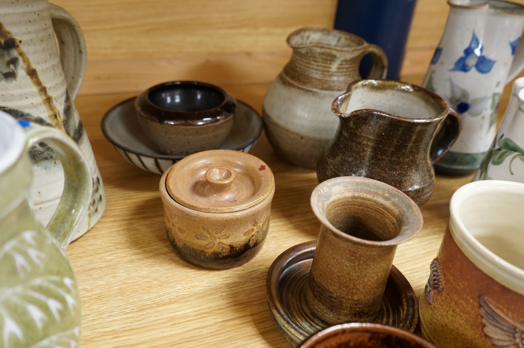 A large collection of studio pottery mugs bowls and jugs, tallest jug 21cm.